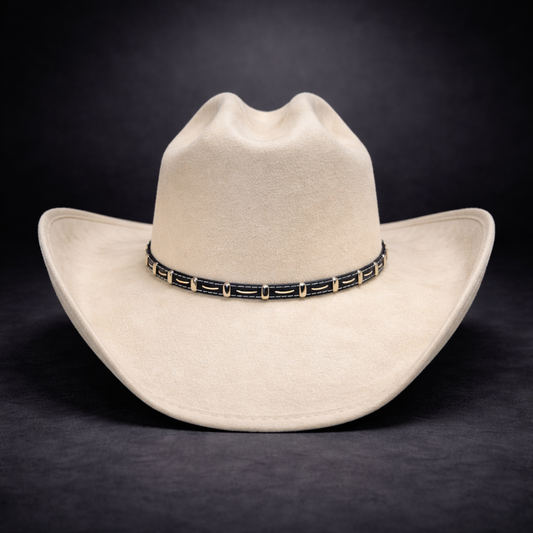 beige cowboy hat with a decorative band on a dark background