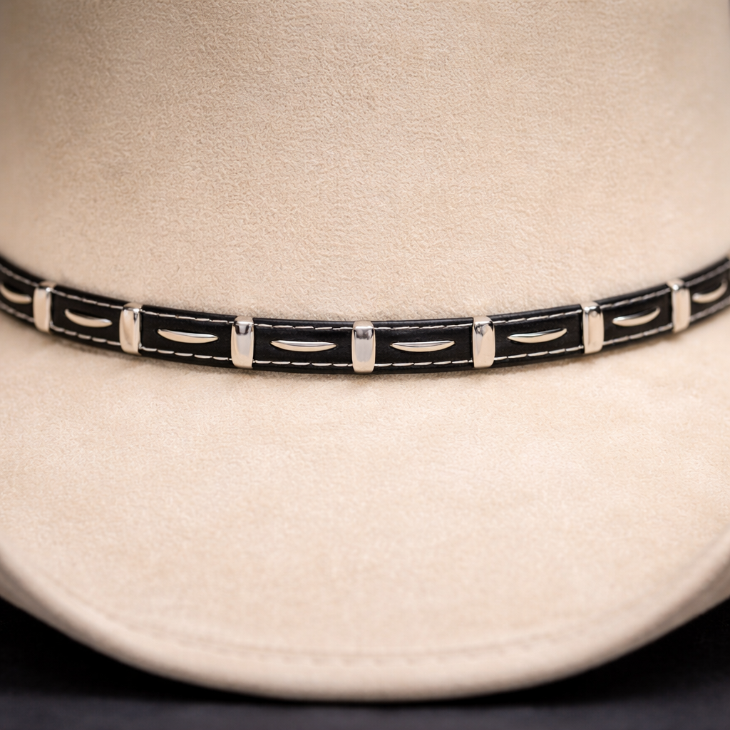 Close-up of a white cowboy hat with a black and silver band