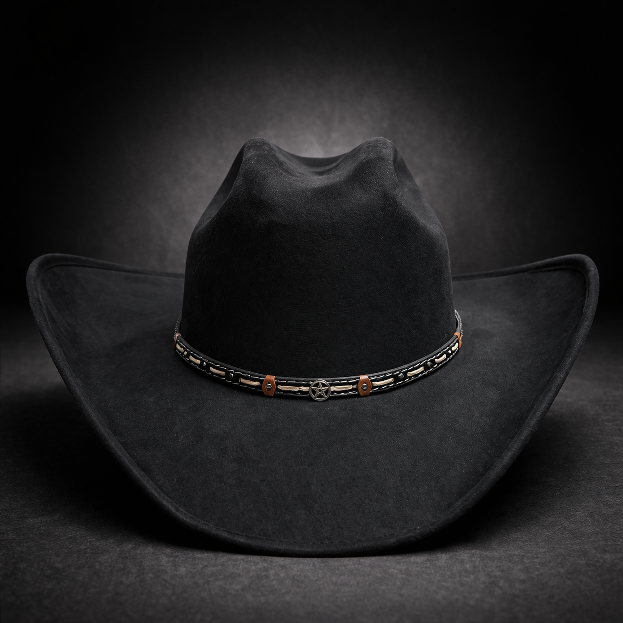Black cowboy hat with a decorative band on a dark background